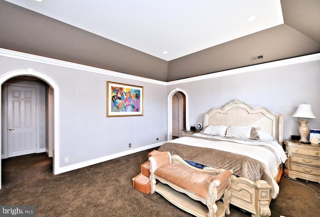 bedroom featuring lofted ceiling and dark colored carpet