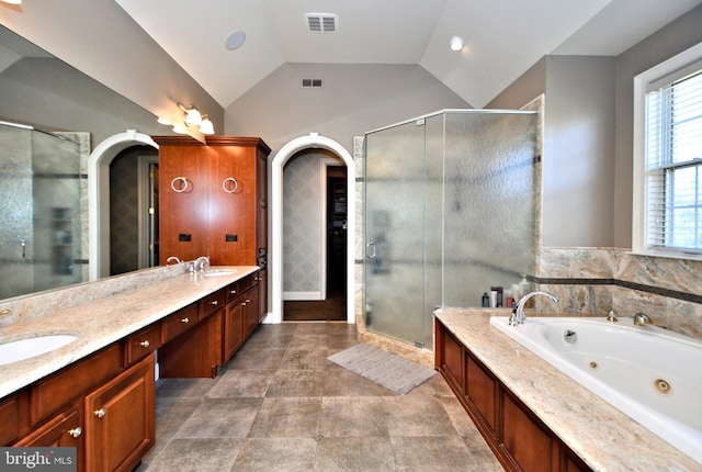 bathroom with lofted ceiling, vanity, and plus walk in shower