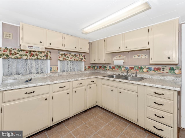 kitchen featuring sink and cream cabinets