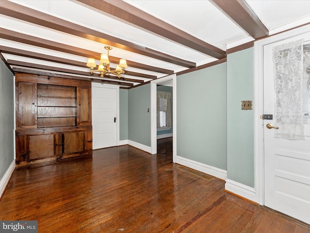 entrance foyer featuring beam ceiling, dark hardwood / wood-style floors, and a chandelier