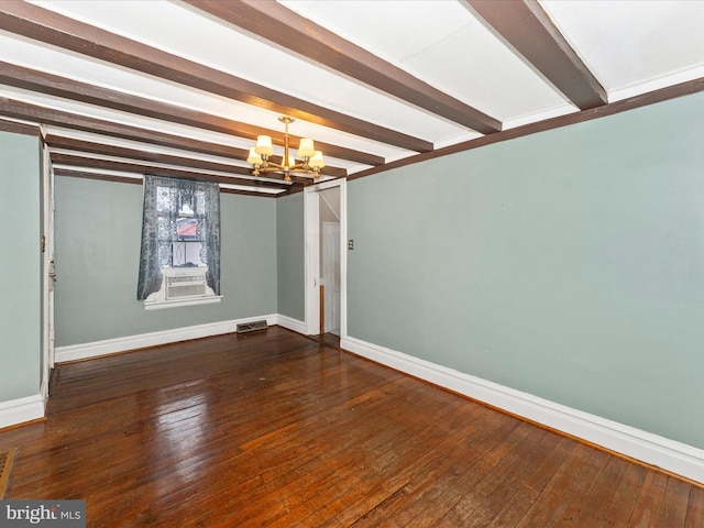 empty room with an inviting chandelier, dark hardwood / wood-style floors, and beamed ceiling