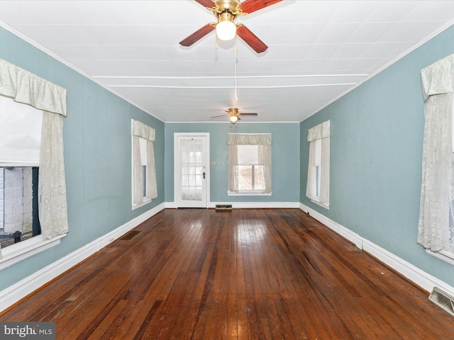 unfurnished room with crown molding, dark wood-type flooring, and ceiling fan