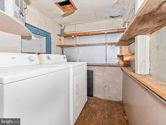 clothes washing area with dark hardwood / wood-style floors and washer and dryer