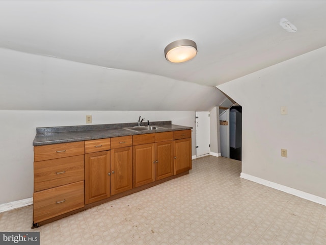 kitchen with lofted ceiling and sink