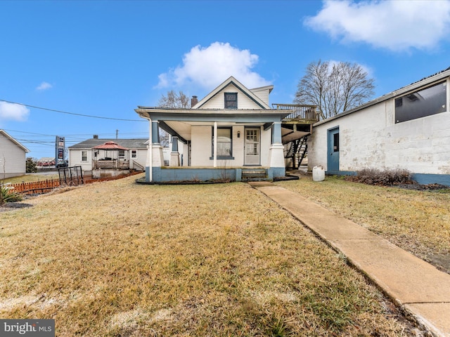 bungalow-style home with a porch and a front lawn