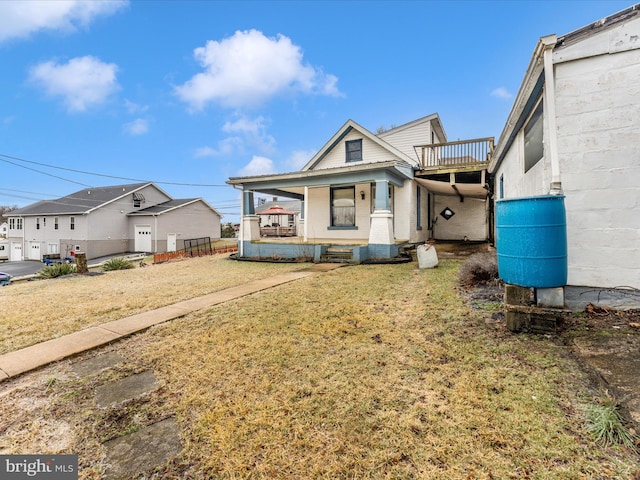 view of front of home with a front yard and covered porch