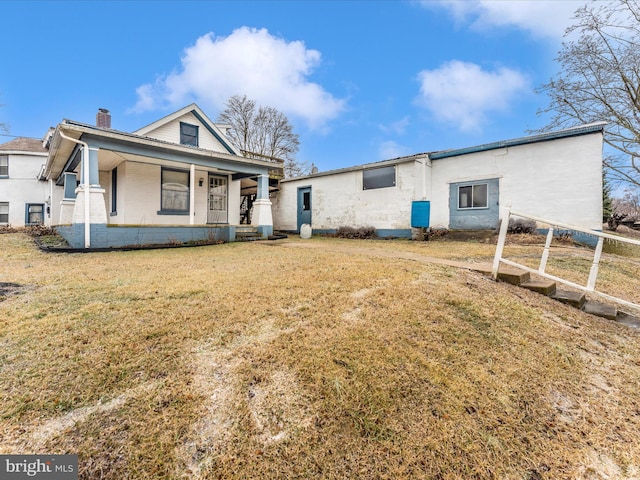 view of front of home with a front yard and covered porch