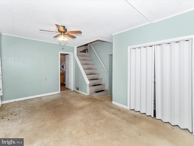 basement with ornamental molding and ceiling fan