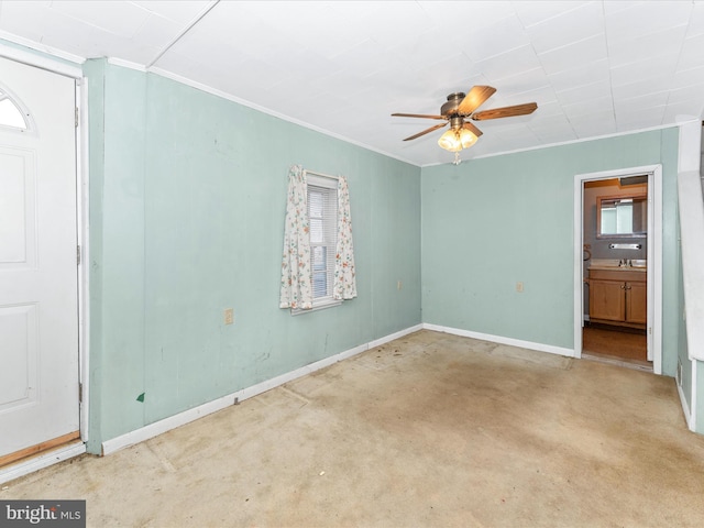 spare room with ornamental molding and ceiling fan