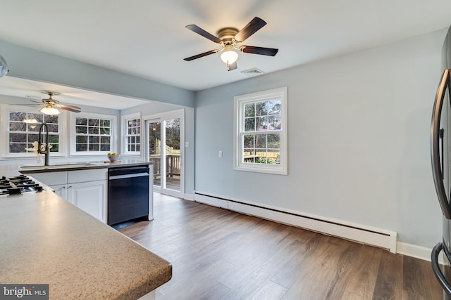 kitchen featuring sink, dark wood-type flooring, dishwasher, white cabinets, and a baseboard radiator