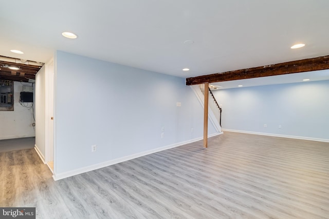 basement with light hardwood / wood-style floors