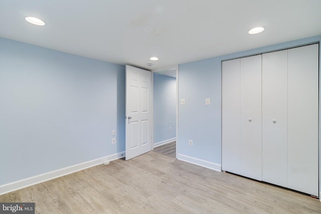 unfurnished bedroom with light hardwood / wood-style floors and a closet