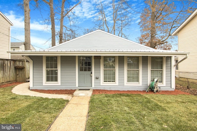 view of front of house with a front yard and covered porch