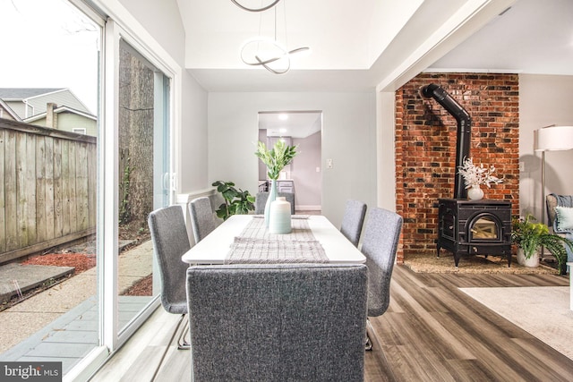 dining area featuring light hardwood / wood-style flooring and a wood stove