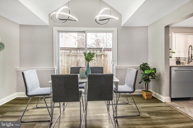 dining space with vaulted ceiling and hardwood / wood-style floors