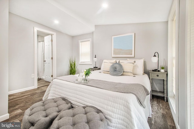 bedroom with vaulted ceiling and dark hardwood / wood-style floors