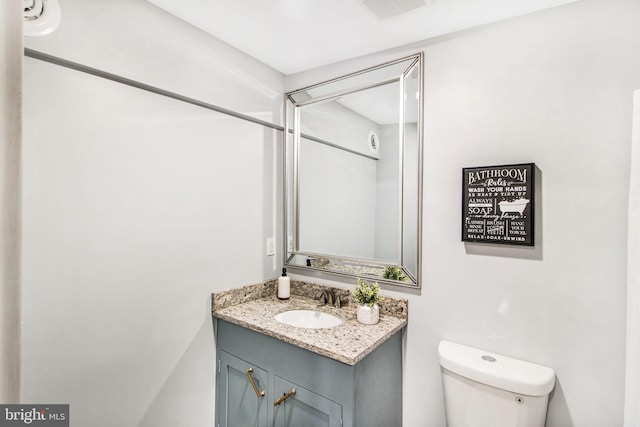 bathroom featuring vanity and toilet