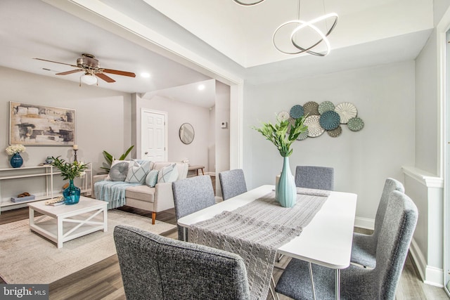 dining area with hardwood / wood-style flooring and ceiling fan