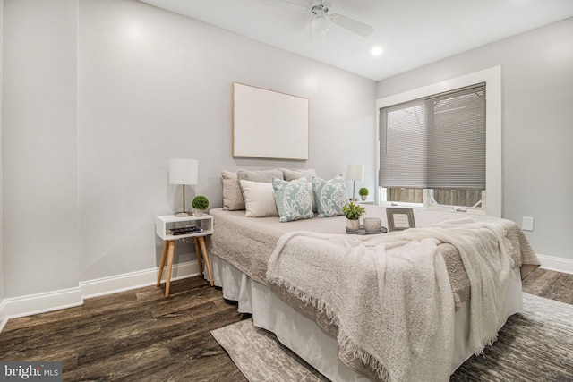 bedroom with dark hardwood / wood-style flooring and ceiling fan