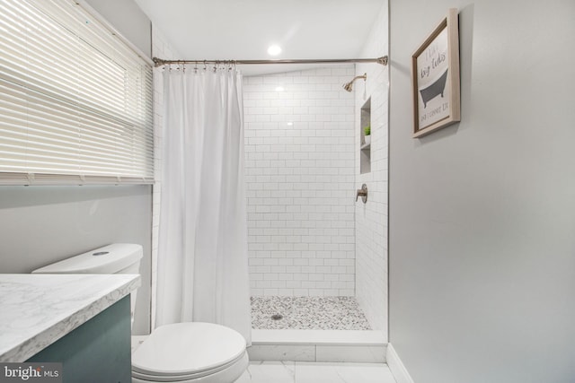 bathroom with vanity, a shower with shower curtain, and toilet