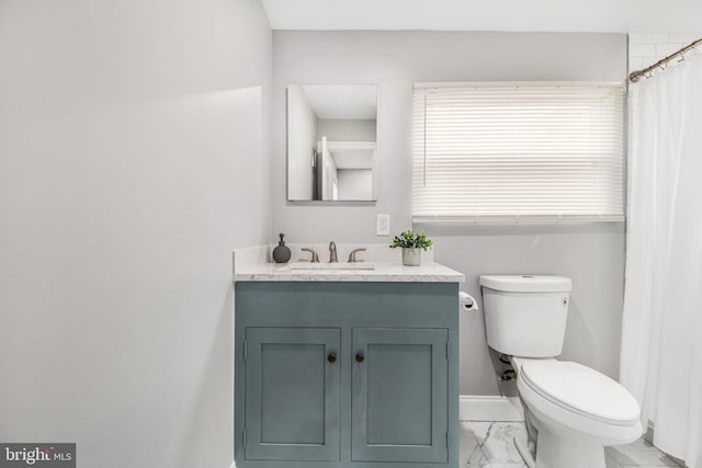 bathroom with vanity, curtained shower, and toilet