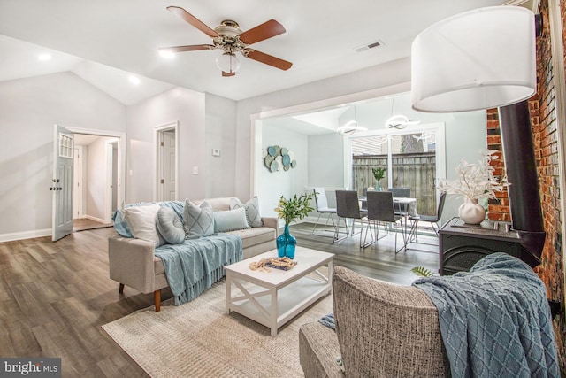 living room featuring hardwood / wood-style flooring, ceiling fan, and vaulted ceiling