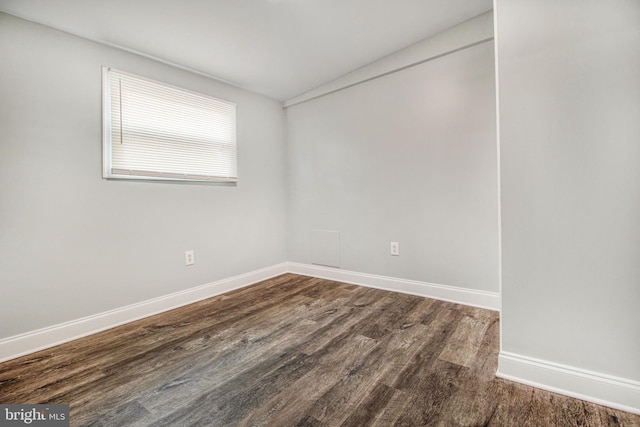 spare room with dark hardwood / wood-style flooring