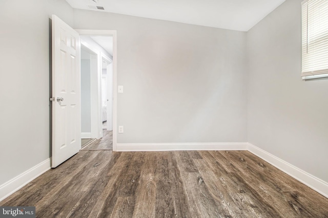 spare room with dark hardwood / wood-style floors