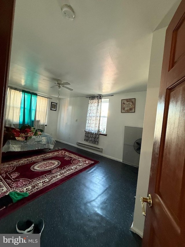 bedroom featuring baseboards, a baseboard heating unit, and ceiling fan