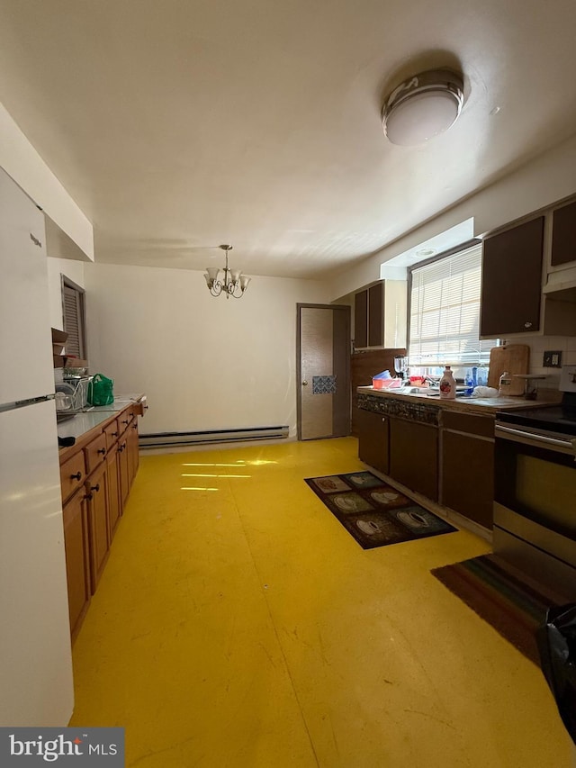 kitchen with concrete flooring, light countertops, baseboard heating, freestanding refrigerator, and stainless steel electric range oven