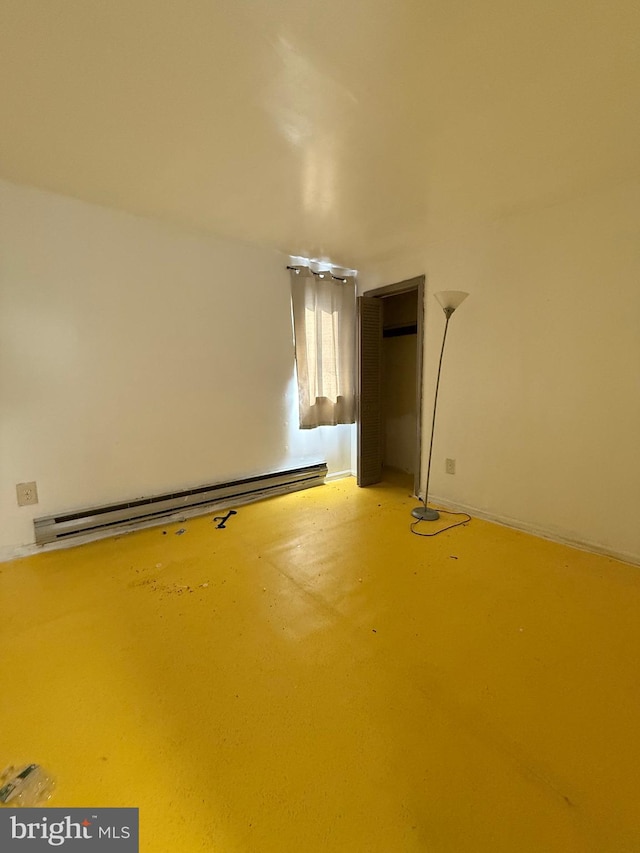 room details featuring concrete flooring and baseboard heating