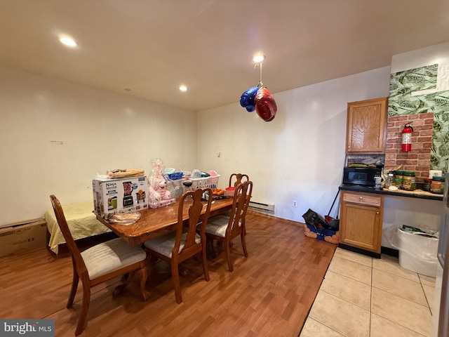 dining area featuring a baseboard heating unit, recessed lighting, and light wood-style floors