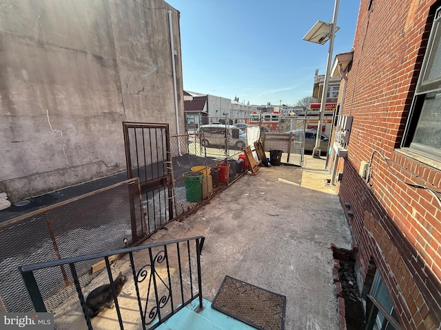 view of patio featuring fence and a gate