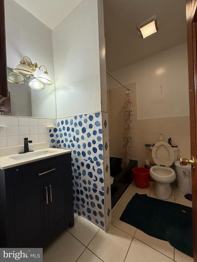 full bath featuring a stall shower, tile patterned flooring, and tile walls