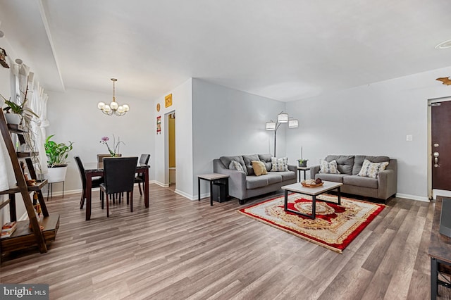 living room featuring an inviting chandelier and wood-type flooring