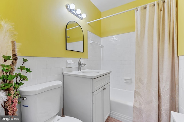 full bathroom featuring vanity, toilet, tile walls, and shower / bath combo