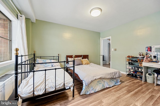 bedroom with hardwood / wood-style floors