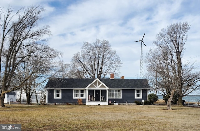 single story home featuring a water view and a front lawn