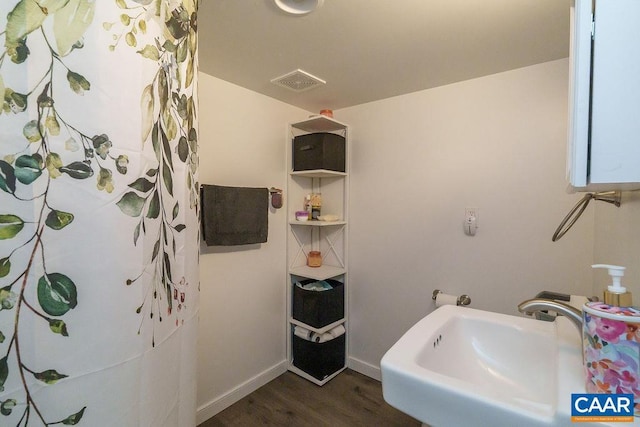 bathroom featuring sink, wood-type flooring, and a shower with shower curtain