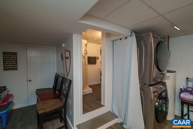 interior space with stacked washer and clothes dryer and hardwood / wood-style floors