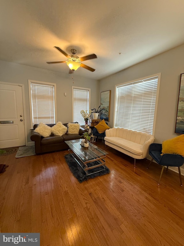 living room featuring ceiling fan and wood finished floors