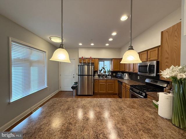 kitchen with black appliances, dark countertops, decorative light fixtures, and recessed lighting