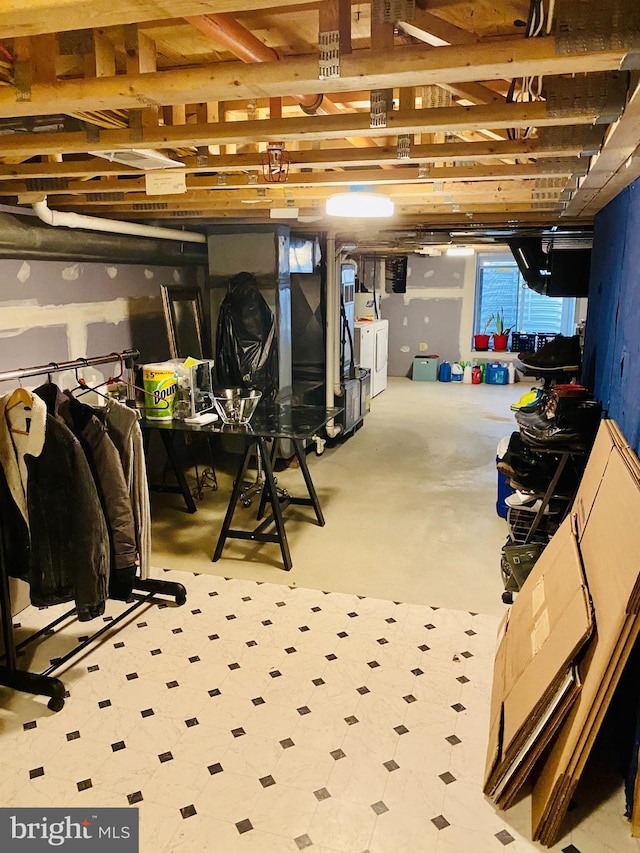 unfinished basement with washer / clothes dryer