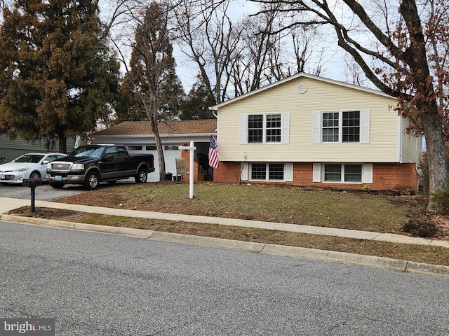 tri-level home with a front lawn and a garage