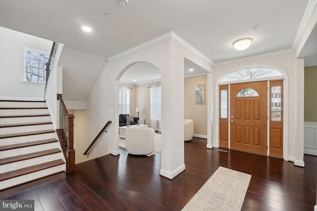 entryway featuring ornamental molding, plenty of natural light, and dark hardwood / wood-style flooring