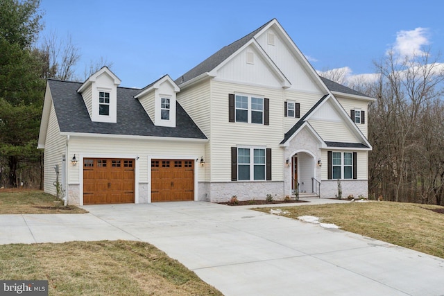 view of front of property with a garage and a front lawn