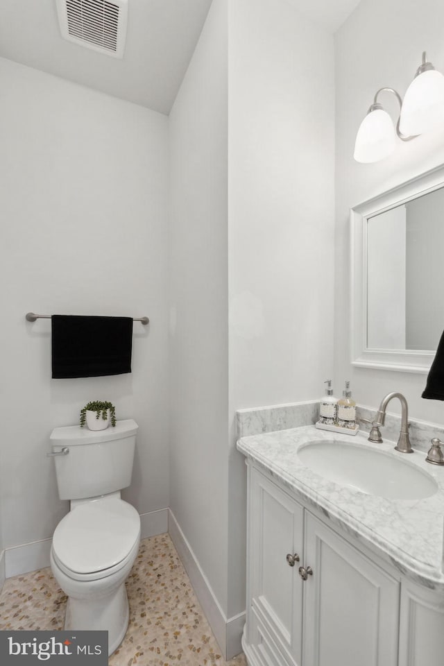 bathroom featuring vanity and toilet