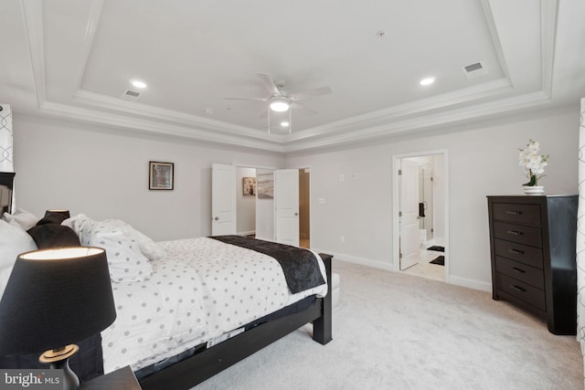 bedroom featuring light colored carpet, ornamental molding, and a raised ceiling