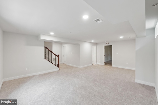 basement featuring light carpet