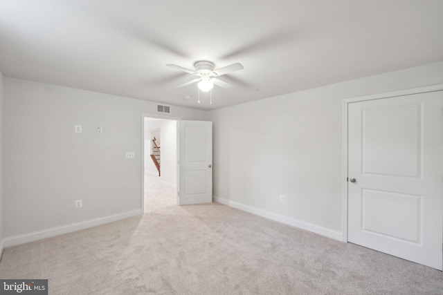 empty room featuring light carpet and ceiling fan